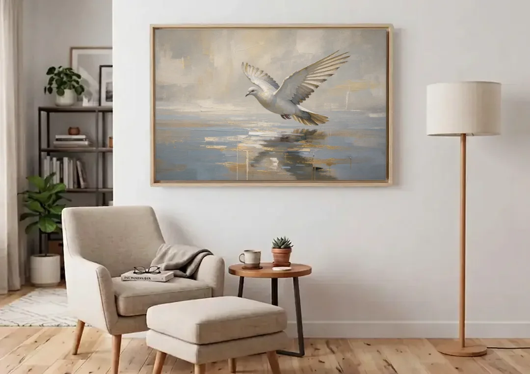 Dove Wall Art with Wings Over Still Water canvas wall art above an armchair in a bright living room