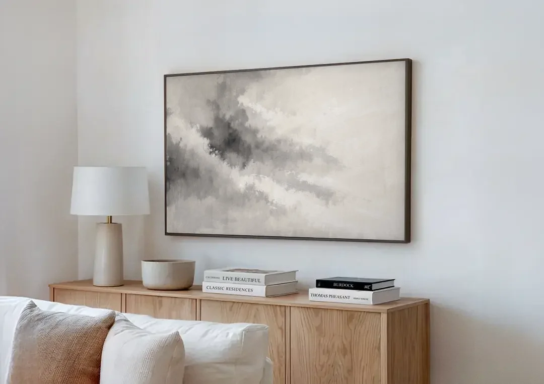 Monochrome Drifting Weather in Soft Gray Wash canvas wall art above a wooden sideboard next to a sofa