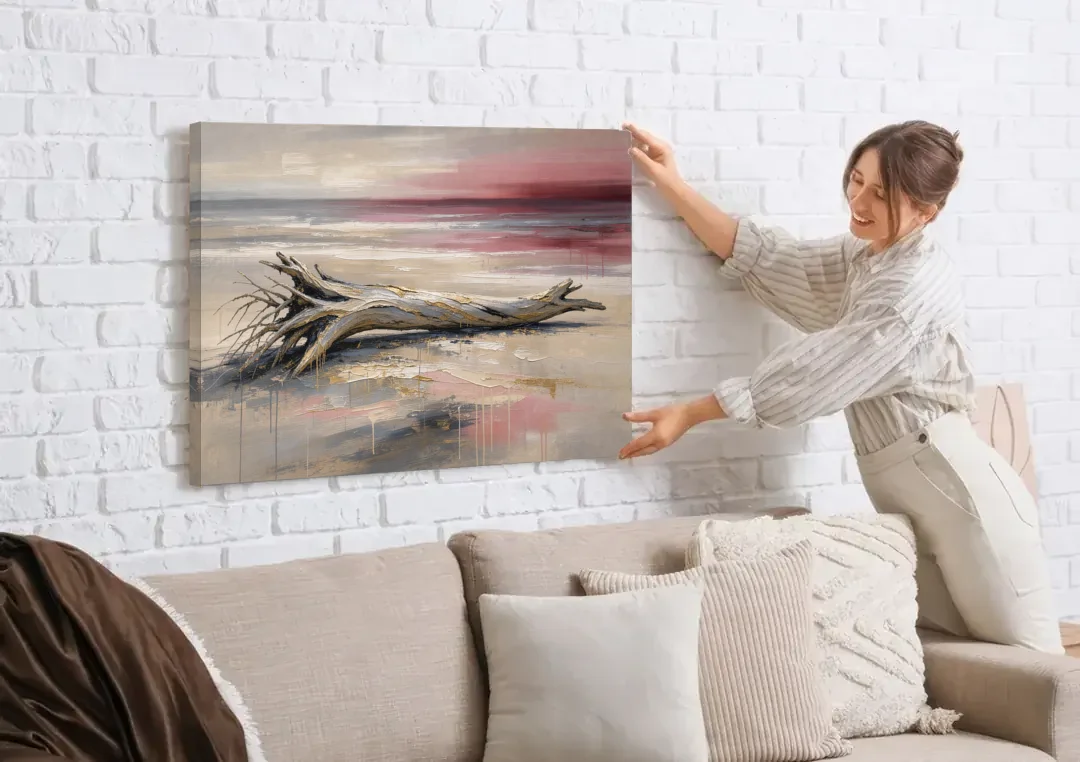 Driftwood Wall Art Under a Rose Dusk Sky canvas wall art being hung on a white brick wall above a sofa