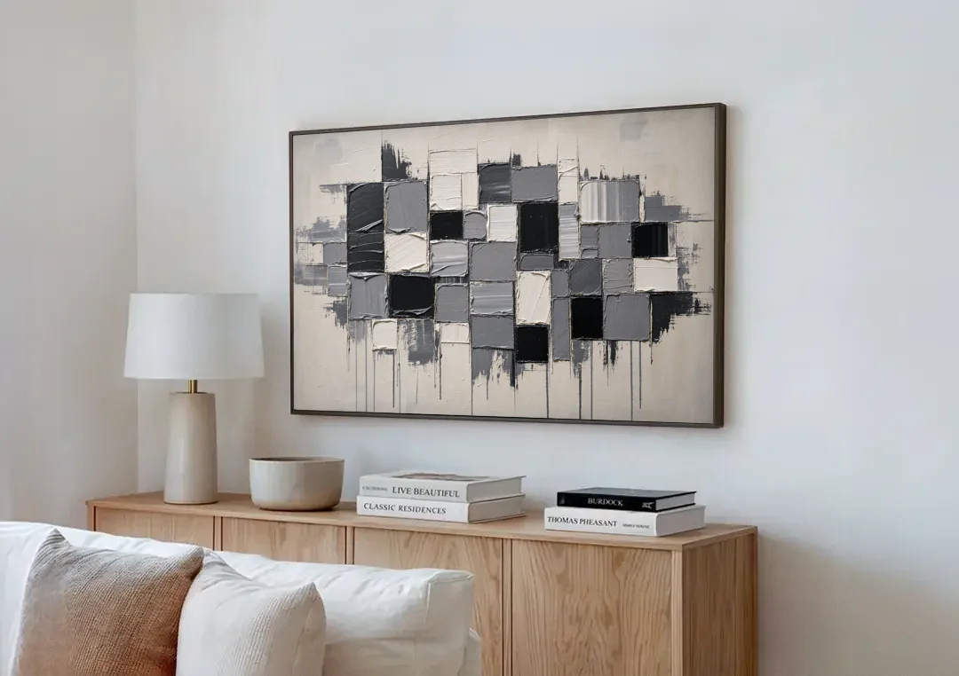Dripping Grid of Black and Grey Squares canvas wall art above a wooden sideboard next to a sofa