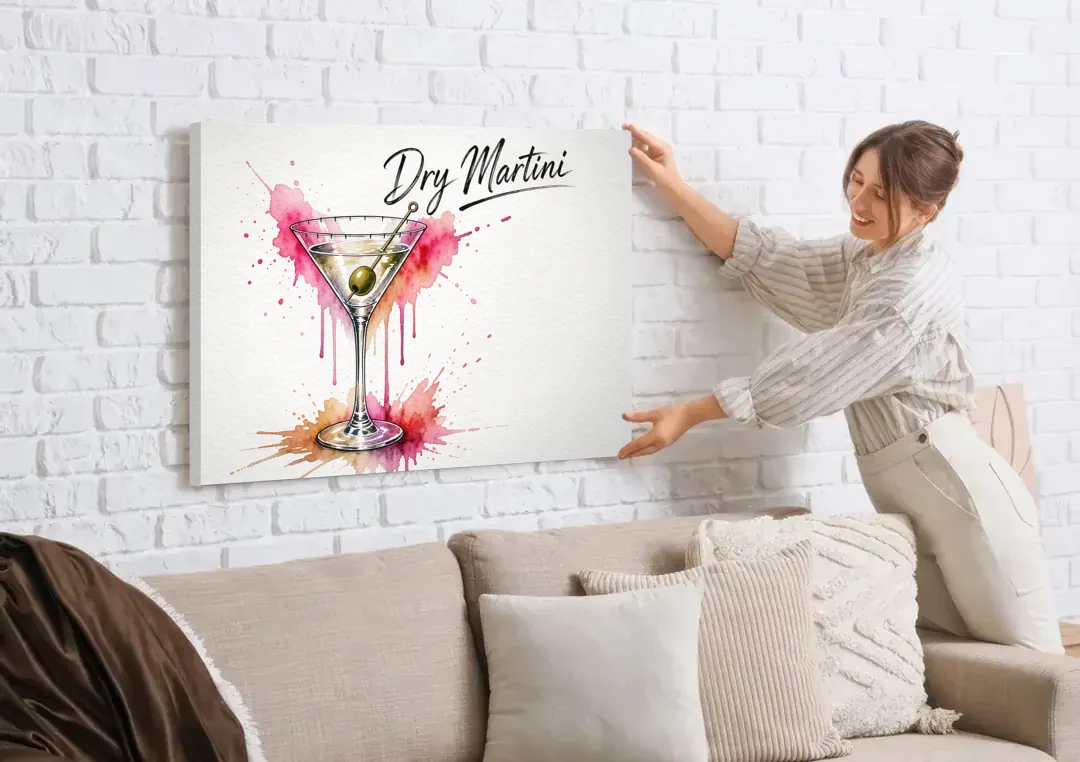Dry Martini Glass with Olive in Pink Watercolor Splash canvas wall art being hung on a white brick wall above a sofa