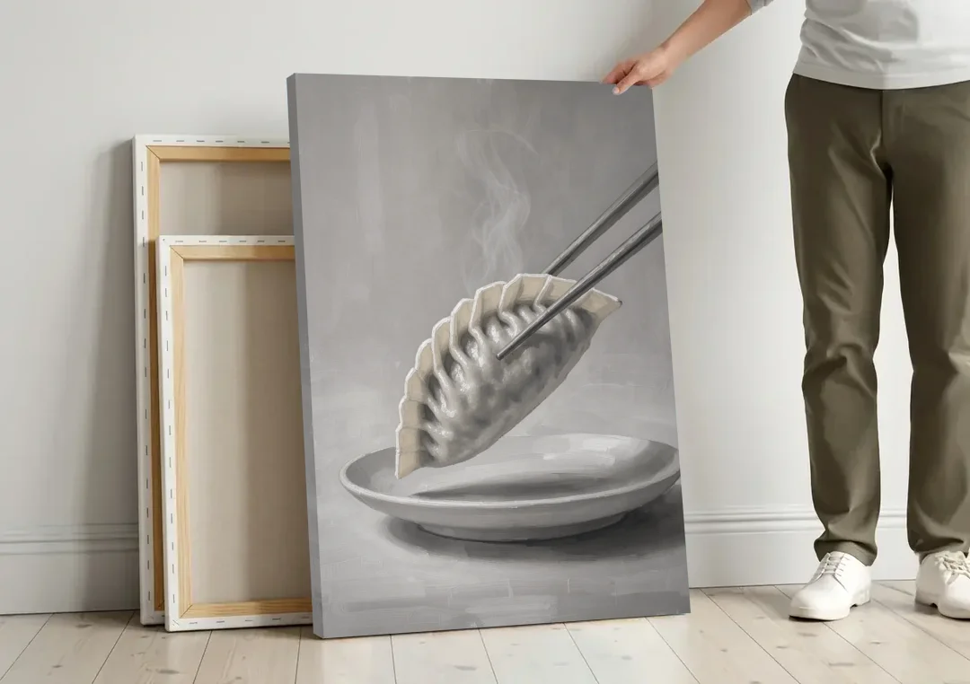 Dumpling Painting with Chopsticks and Steam canvas wall art leaning against a wall next to blank canvases
