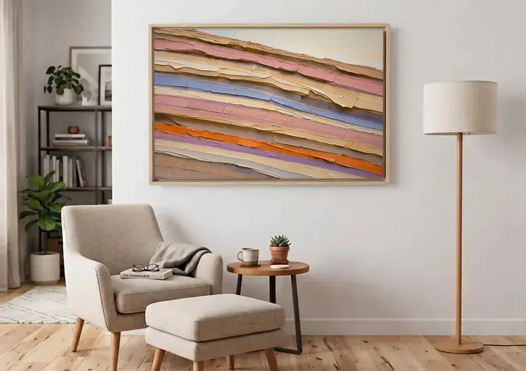 Earth Tone Abstract Eroded Canyon Strata canvas wall art above an armchair in a bright living room