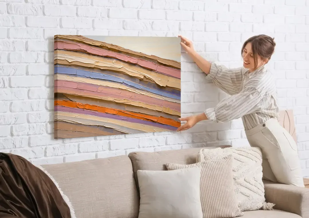 Earth Tone Abstract Eroded Canyon Strata canvas wall art being hung on a white brick wall above a sofa