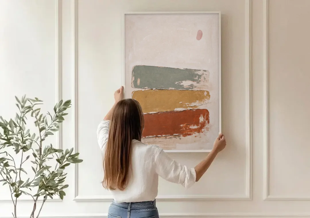 Earthy Abstract Painting with Blush Pebble canvas wall art being hung on a paneled wall