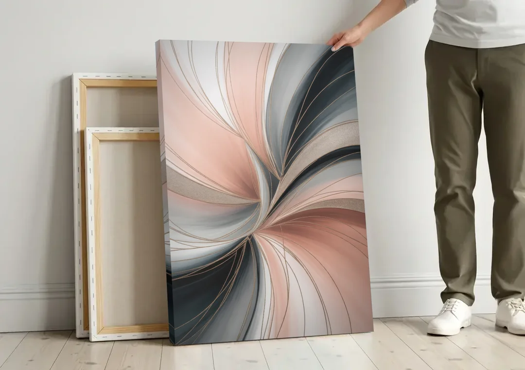Elegant Curves Pink and Grey Abstract canvas wall art leaning against a wall next to blank canvases