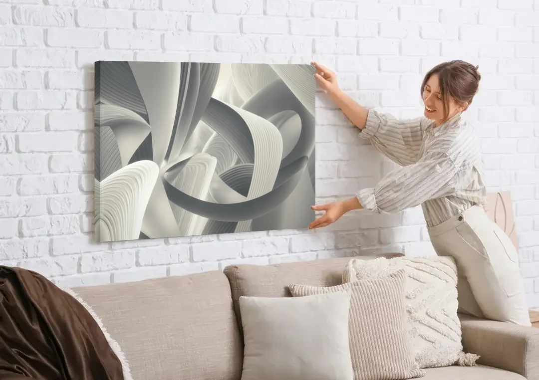 Elegant Flow Grey and White Abstract canvas wall art being hung on a white brick wall above a sofa