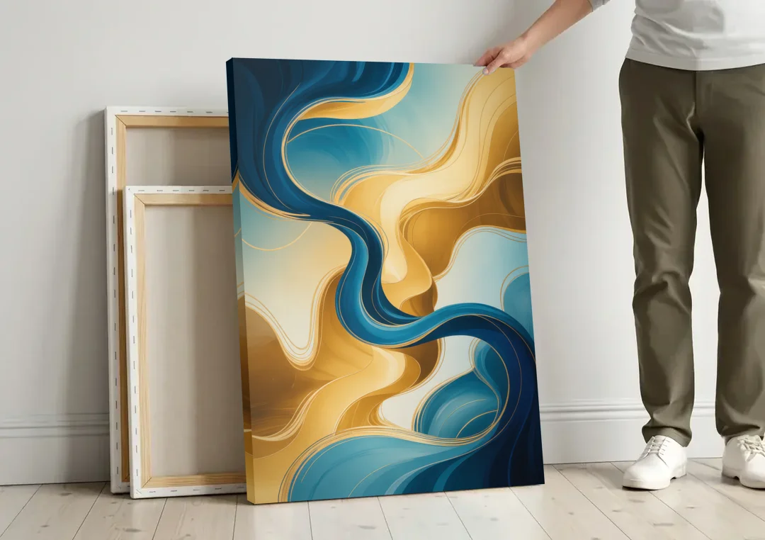 Elegant Fluidity Blue and Gold Abstract canvas wall art leaning against a wall next to blank canvases