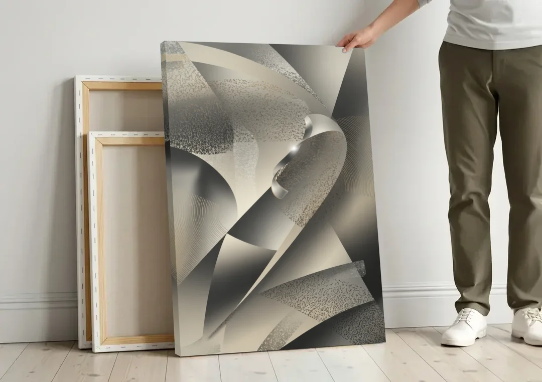 Elegant Geometric Flow Grey and Silver Abstract canvas wall art leaning against a wall next to blank canvases
