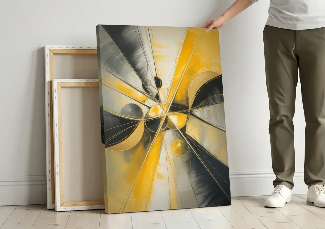 Elegant Harmony Yellow and Grey Abstract canvas wall art leaning against a wall next to blank canvases