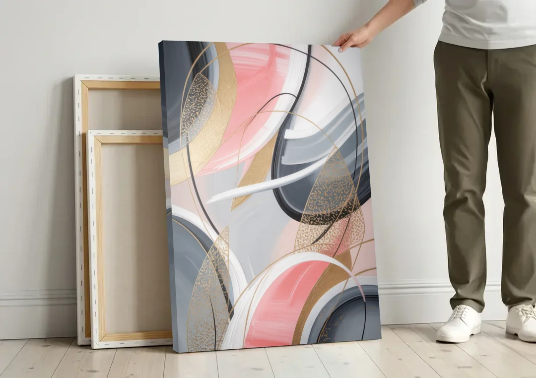 Elegant Opulence Pink and Grey Abstract canvas wall art leaning against a wall next to blank canvases