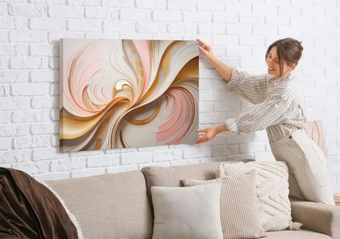 Elegant Radiance Pink and Gold Abstract canvas wall art being hung on a white brick wall above a sofa