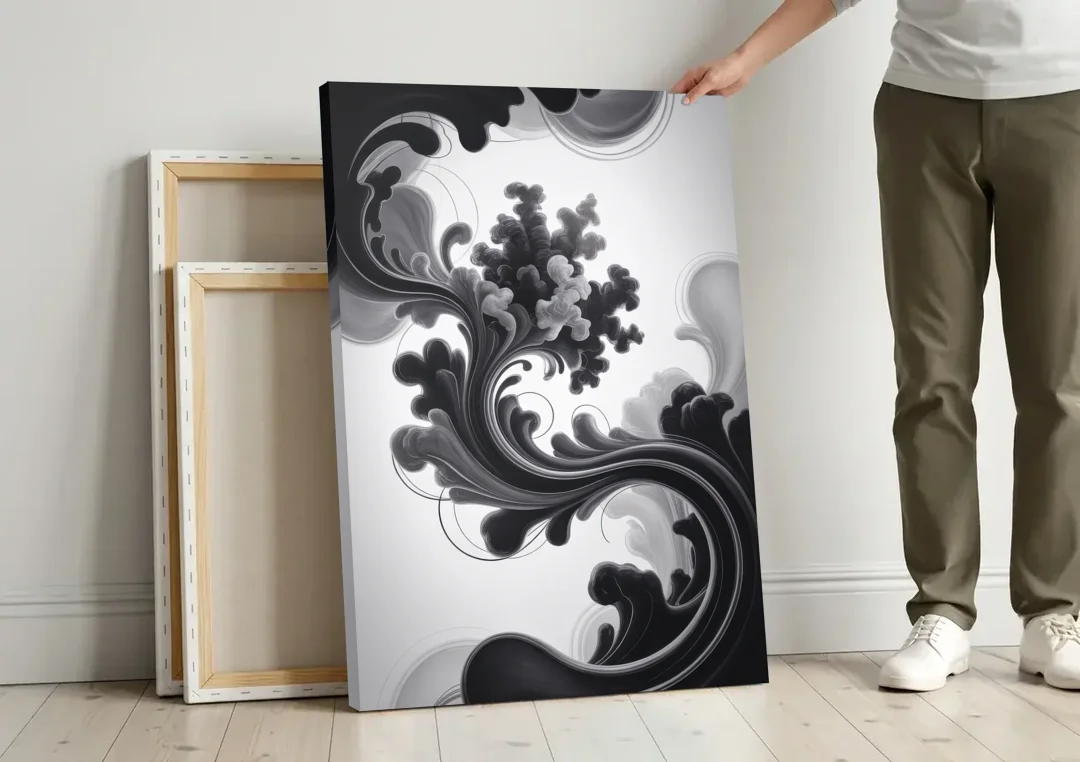 Elegant Swirls Black and White Abstract canvas wall art leaning against a wall next to blank canvases