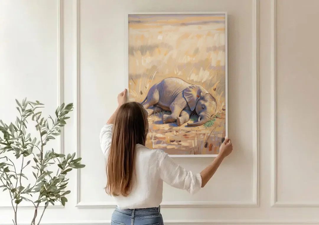 Elephant Calf Asleep on Its Side canvas wall art being hung on a paneled wall