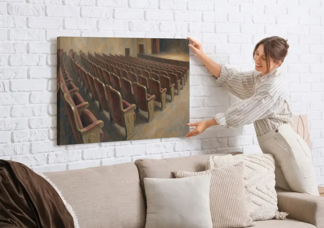 Empty Red Velvet Theater Seats in Soft Haze canvas wall art being hung on a white brick wall above a sofa