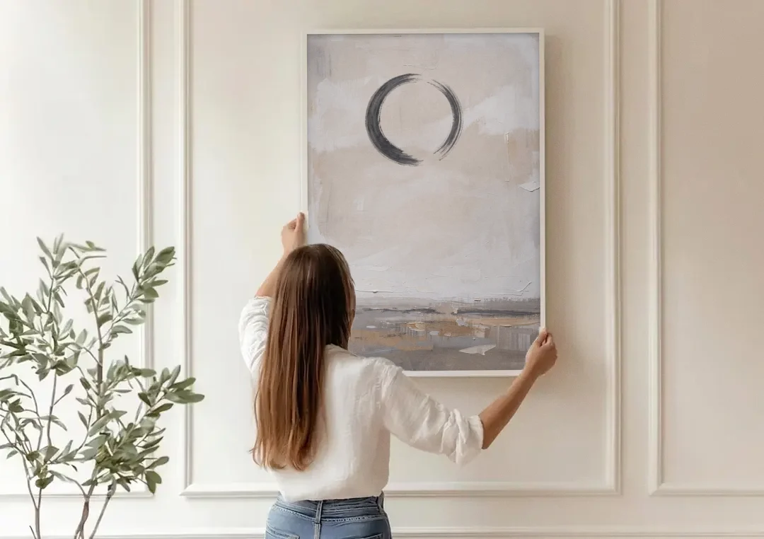Enso Circle Painting Over Warm Sand canvas wall art being hung on a paneled wall