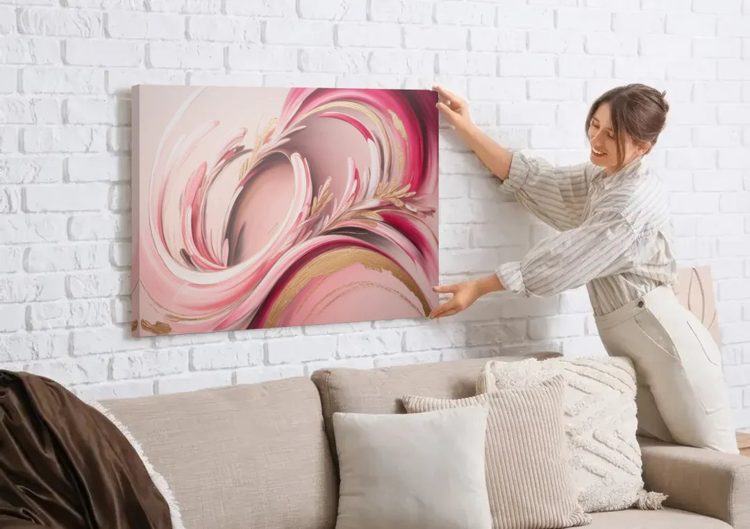 Ethereal Elegance Pink Abstract canvas wall art being hung on a white brick wall above a sofa
