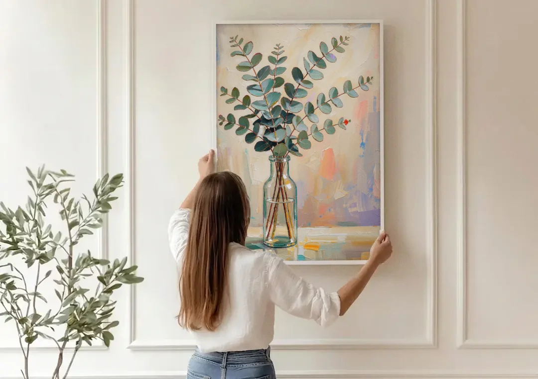 Eucalyptus Canvas Print in a Glass Bottle canvas wall art being hung on a paneled wall