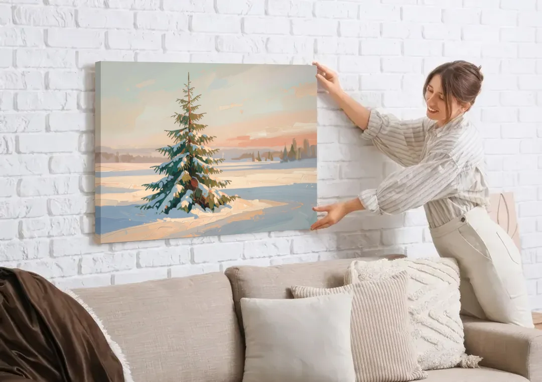 Evergreen Tree Painting of a Lone Snowy Fir canvas wall art being hung on a white brick wall above a sofa
