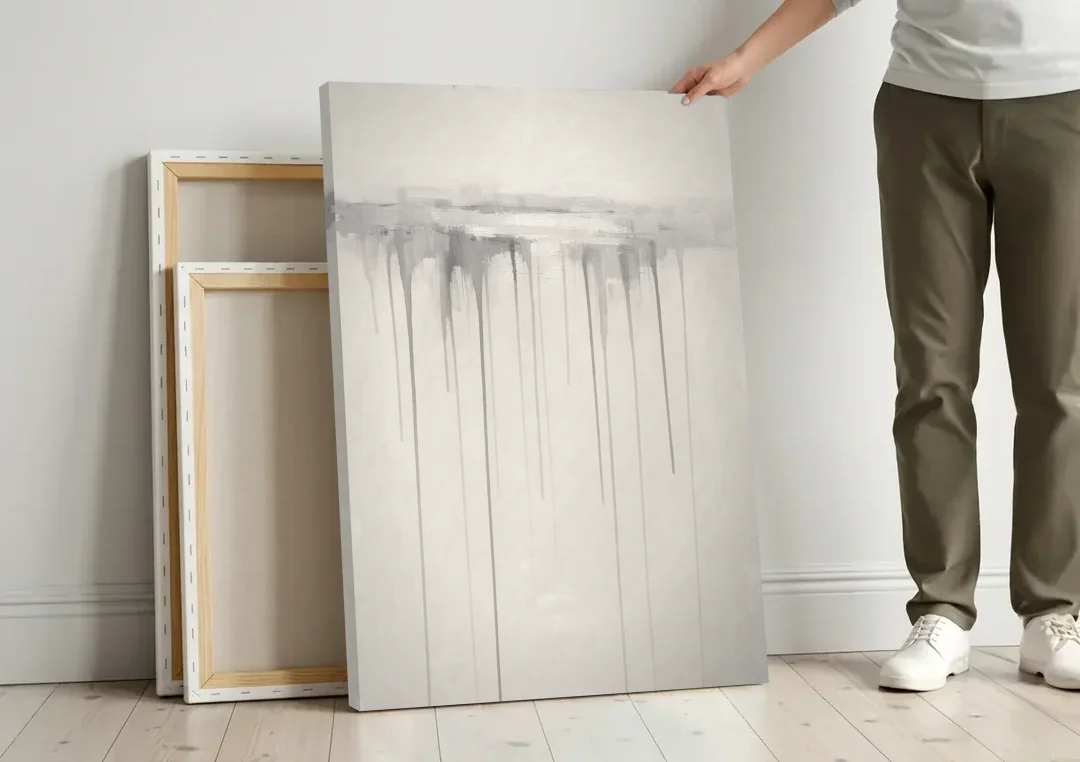 Falling Grey Rain Lines for the Dining Room canvas wall art leaning against a wall next to blank canvases