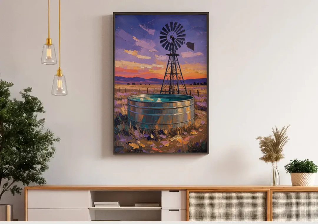 Farm Landscape Painting with Windmill and Stock Tank canvas wall art above a wooden sideboard under pendant lights