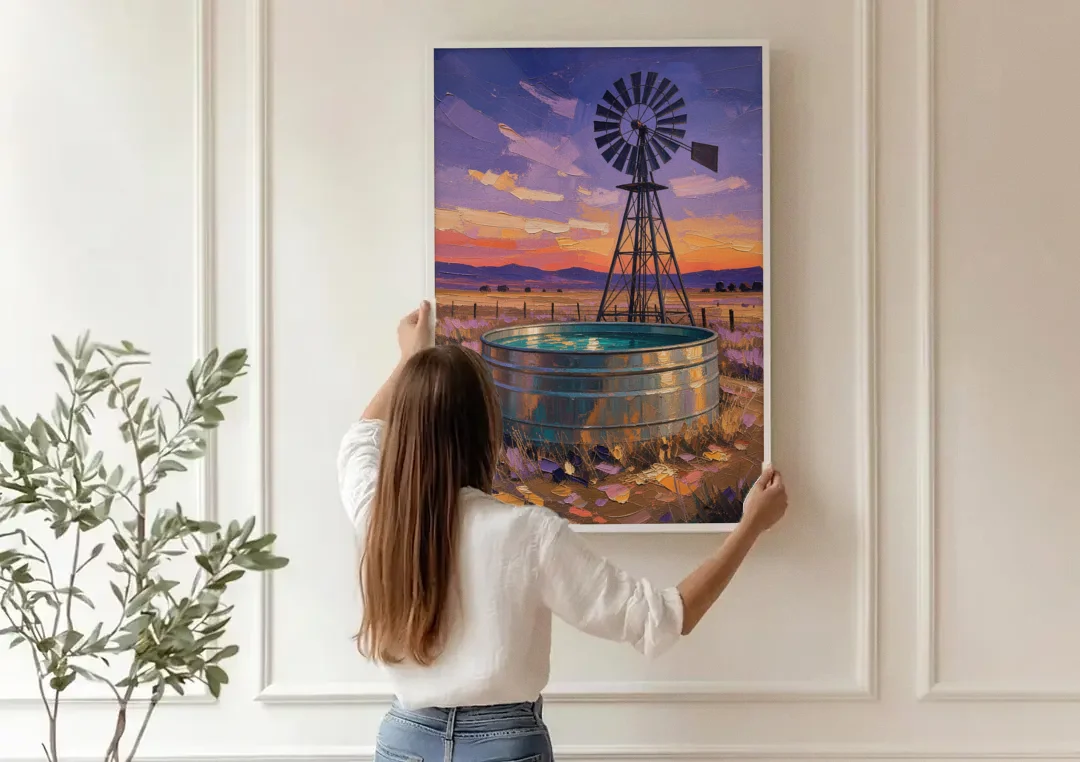 Farm Landscape Painting with Windmill and Stock Tank canvas wall art being hung on a paneled wall