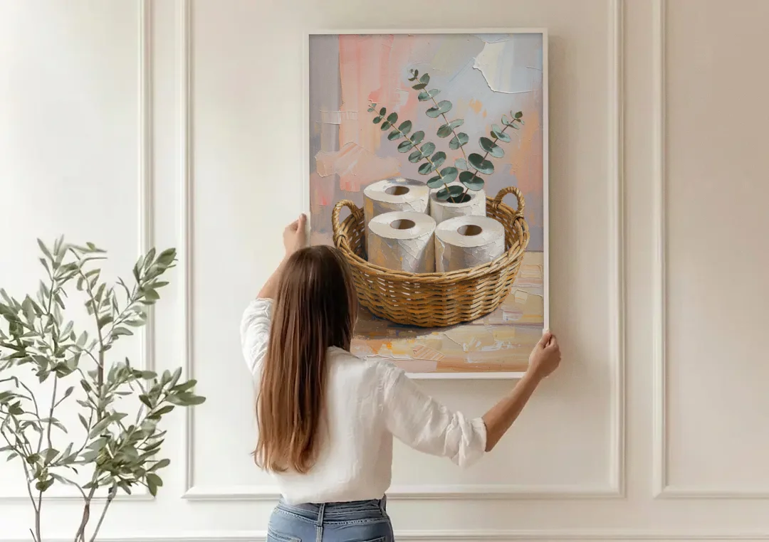 Farmhouse Bathroom Wall Decor with Wicker Basket and Eucalyptus canvas wall art being hung on a paneled wall