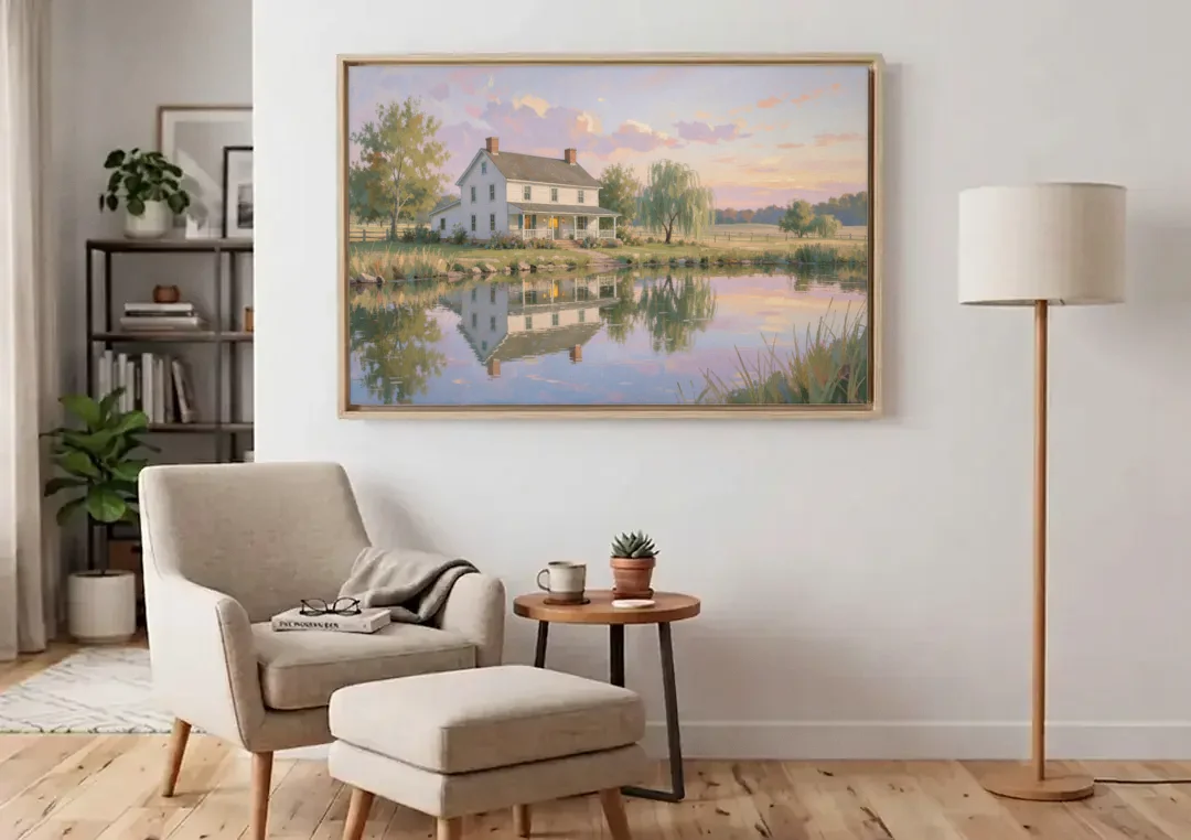 Farmhouse Landscape Painting by the Evening Pond canvas wall art above an armchair in a bright living room