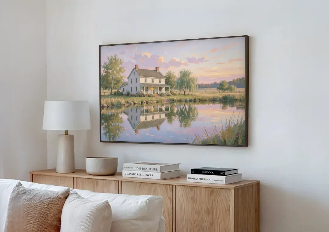 Farmhouse Landscape Painting by the Evening Pond canvas wall art above a wooden sideboard next to a sofa