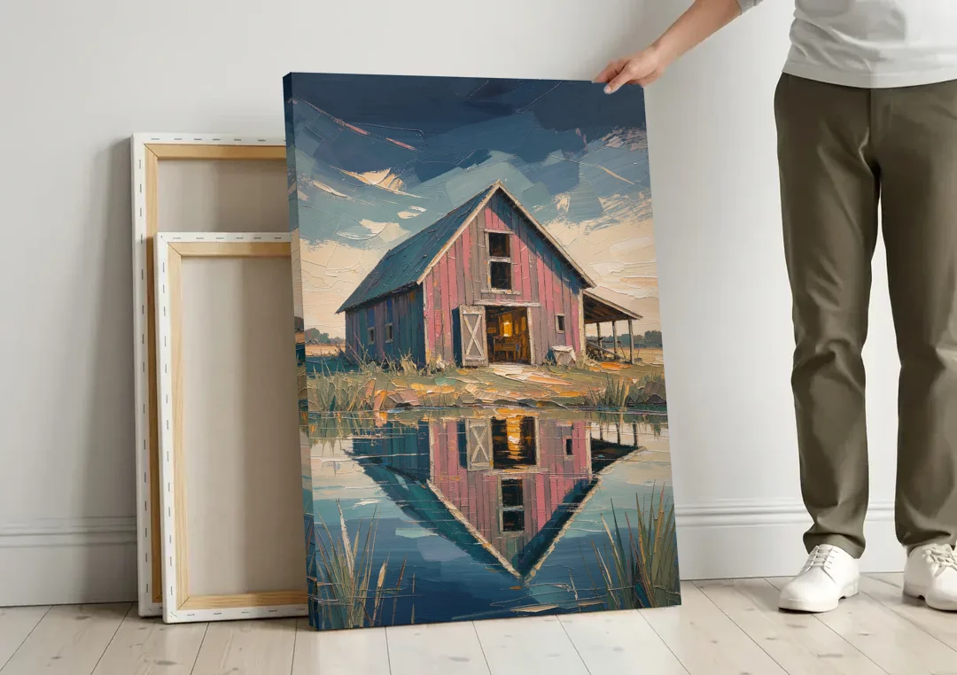 Farmhouse Red Barn Reflected in the Farm Pond canvas wall art leaning against a wall next to blank canvases