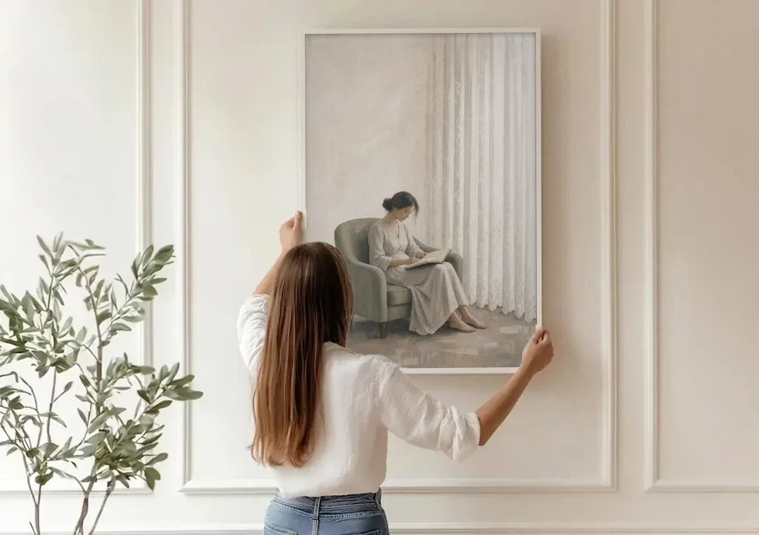 Feminine Wall Art Reader in the Sage Armchair canvas wall art being hung on a paneled wall