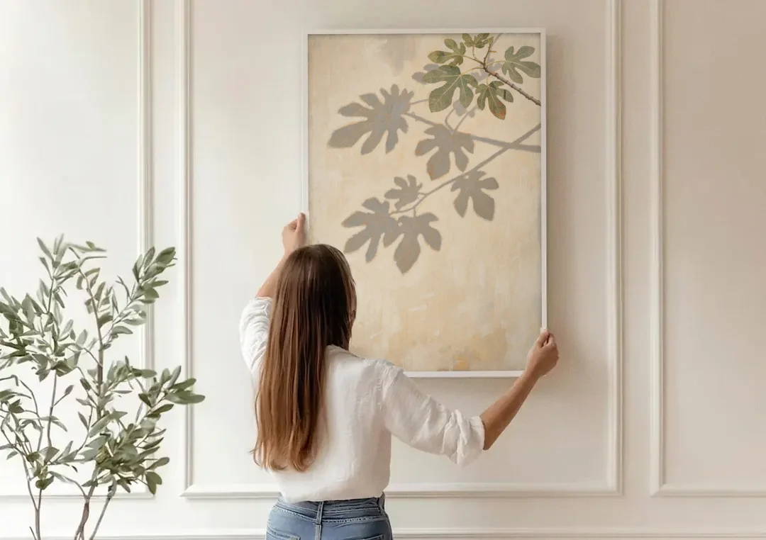 Fig Leaf Shadows on a Sunlit Limewashed Wall canvas wall art being hung on a paneled wall