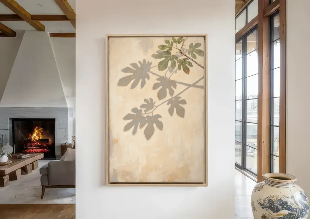 Fig Leaf Shadows on a Sunlit Limewashed Wall canvas wall art in a living room with a fireplace