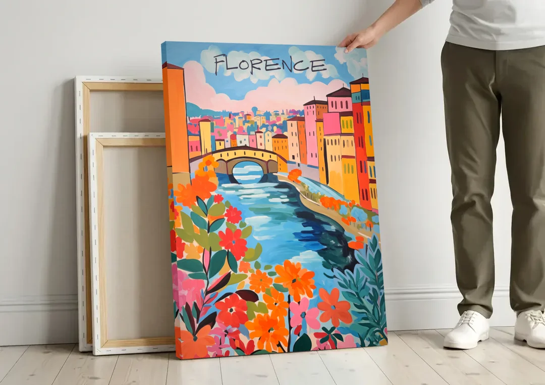 Florence Painting of the Arno in Bloom canvas wall art leaning against a wall next to blank canvases