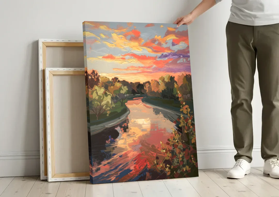 Fort Wayne Sunset Over River canvas wall art leaning against a wall next to blank canvases