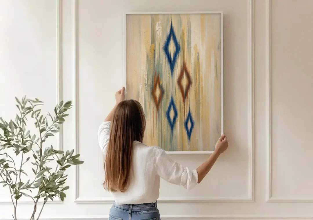 Framed Abstract Painting of Drifting Ikat Diamonds canvas wall art being hung on a paneled wall