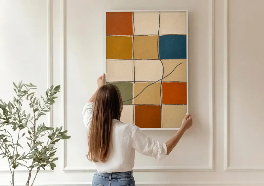 Framed Geometric Wall Art with a Wandering Line canvas wall art being hung on a paneled wall