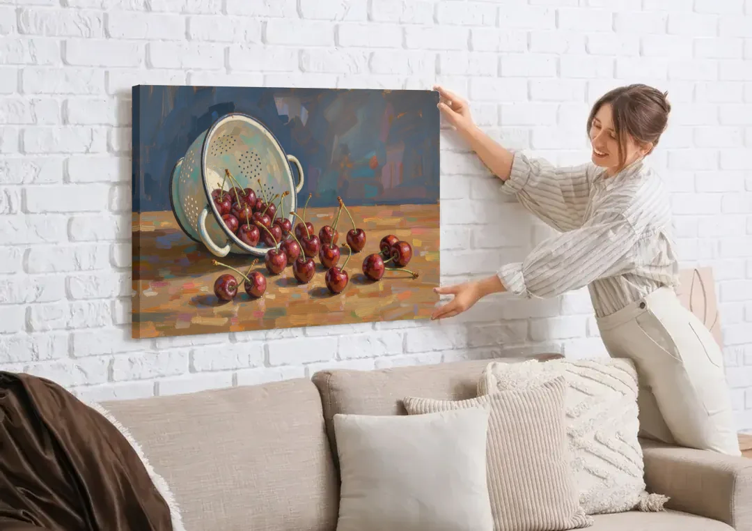 Fruit Still Life Painting with Spilled Cherries canvas wall art being hung on a white brick wall above a sofa