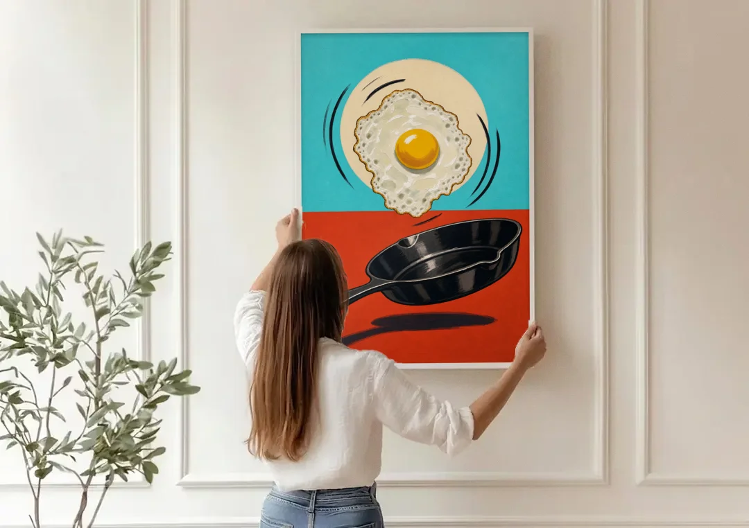 Funny Kitchen Wall Art with a Flipping Fried Egg canvas wall art being hung on a paneled wall