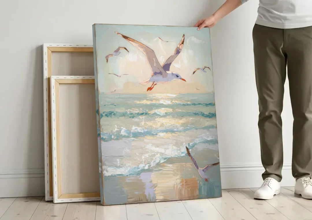 Galveston Seagulls in Flight canvas wall art leaning against a wall next to blank canvases