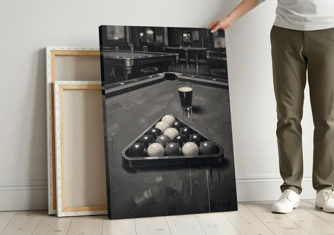 Game Room Wall Art with Racked Balls and Stout canvas wall art leaning against a wall next to blank canvases