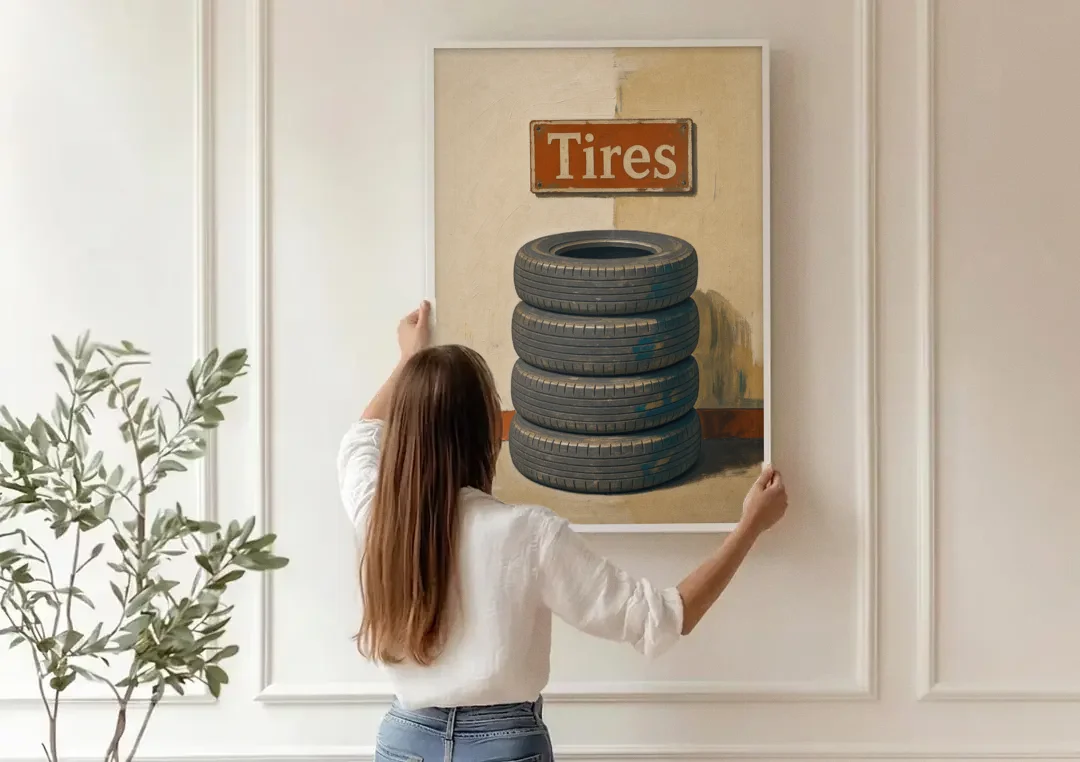 Garage Man Cave Decor with Stacked Old Tires canvas wall art being hung on a paneled wall
