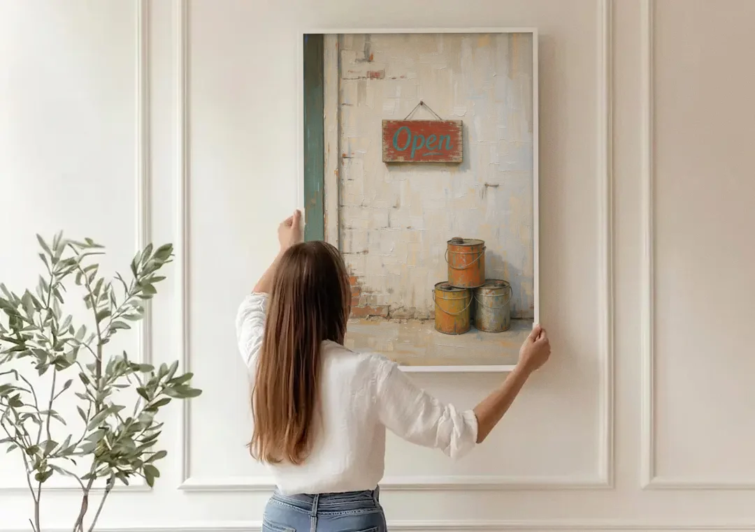 Garage Wall Decor Open Sign and Oil Cans canvas wall art being hung on a paneled wall