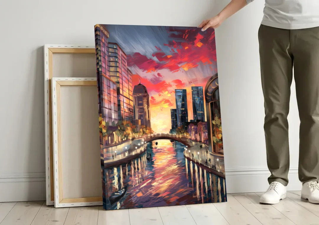 Garland Cityscape Sunset canvas wall art leaning against a wall next to blank canvases