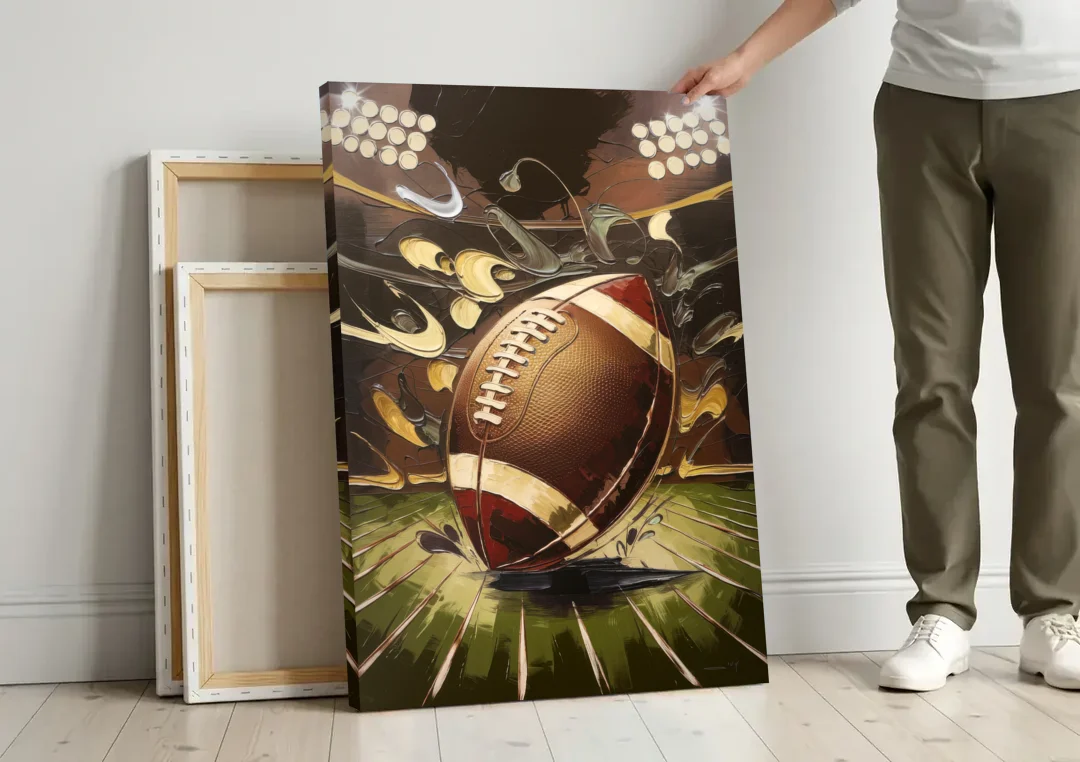 Garland Football Spirit canvas wall art leaning against a wall next to blank canvases