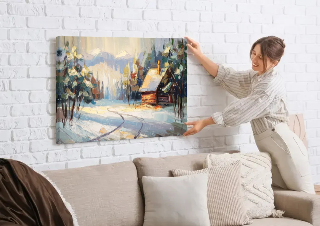 Gatlinburg Winter Wonderland canvas wall art being hung on a white brick wall above a sofa