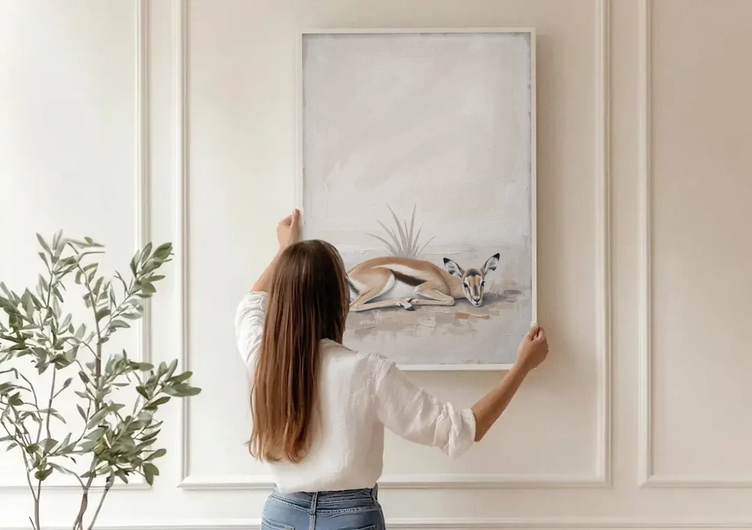 Gazelle Fawn Lying Low in Hiding canvas wall art being hung on a paneled wall