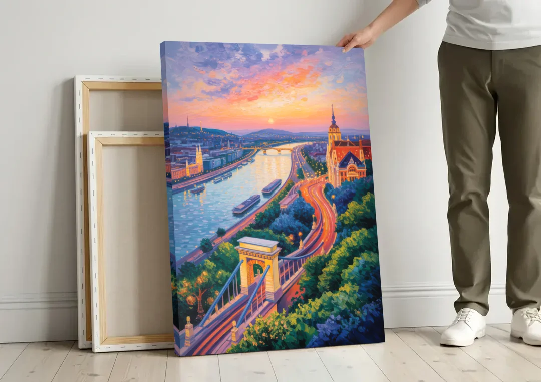 Gellért Hill Sunset canvas wall art leaning against a wall next to blank canvases