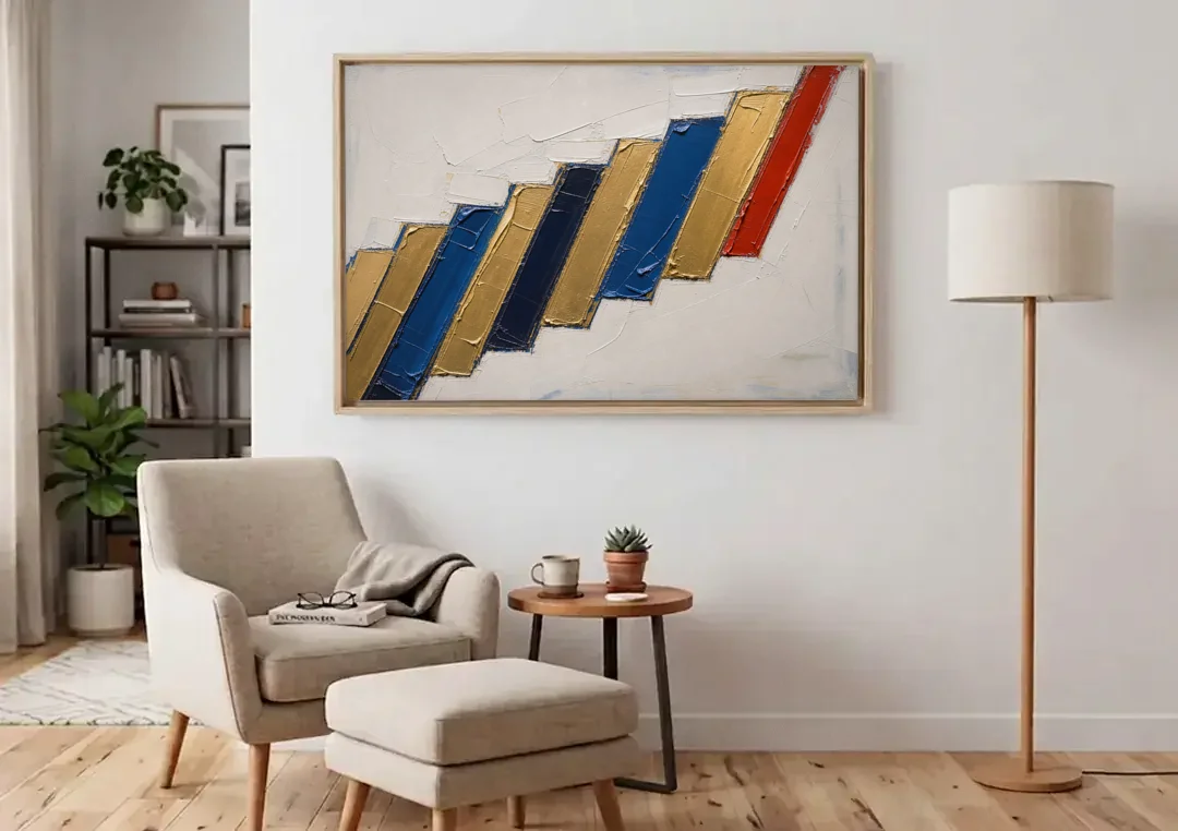 Geometric Abstract Wall Art in Cobalt and Gold Steps canvas wall art above an armchair in a bright living room