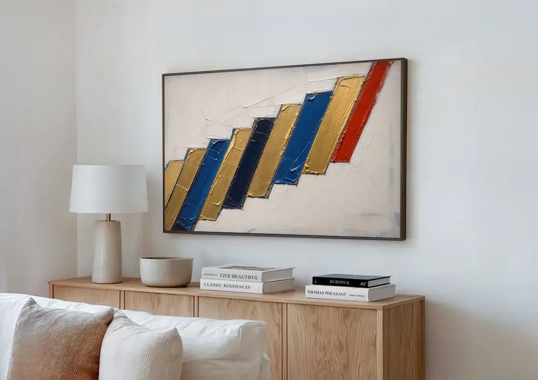 Geometric Abstract Wall Art in Cobalt and Gold Steps canvas wall art above a wooden sideboard next to a sofa